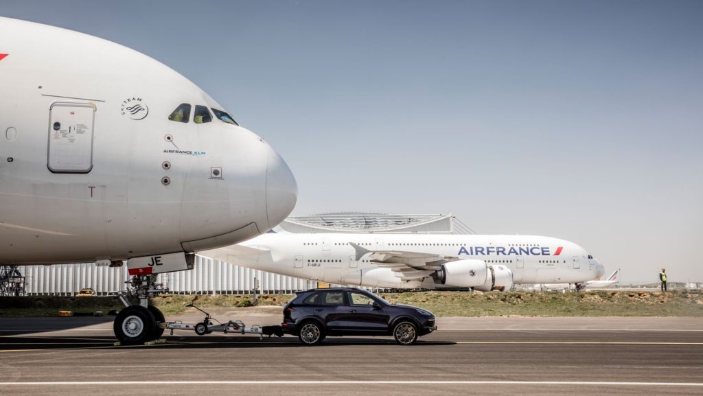 Porsche Cayenne S Diesel pulls one of Air France's 285 tonne A380 at Charles de Gaulle Airport in Paris